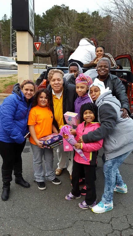 GSG members and families outdoors with toys